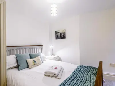 a bedroom with a white bed with towels on it at Apartment 1 - Uk32244 in Aberdyfi
