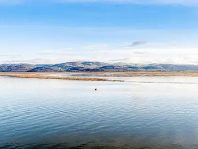 a body of water with mountains in the background at Apartment 1 - Uk32244 in Aberdyfi