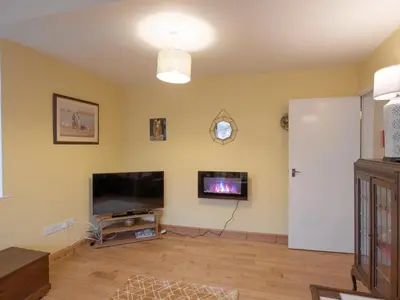 a living room with a television and a flat screen tv at The Coach House in Oswestry