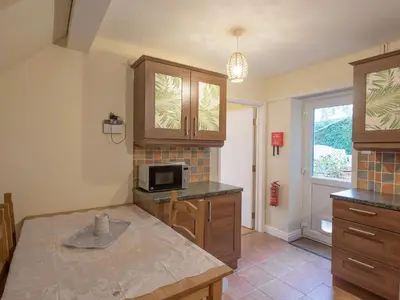 a kitchen with a counter top and a microwave at The Coach House in Oswestry