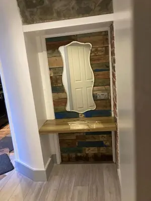 a stairway with a wooden wall with a white door at Cadwgan House in Rhayader