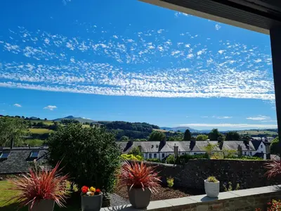 a view from the garden of a house with plants at Camden Lodge B&B and Cottage Brecon in Brecon