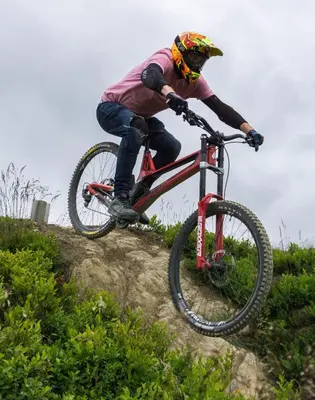 a man riding a bike down a hill at Chapel Cottage in Machynlleth