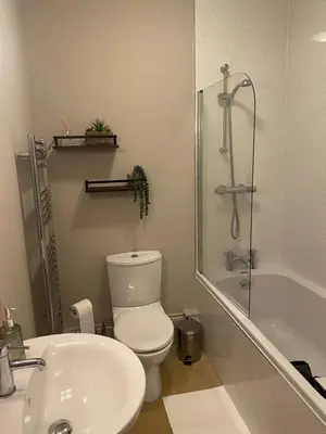 a bathroom with a toilet and a sink and a shower at Lan Y Môr 4 Aberystwyth in Aberystwyth
