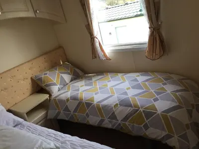 a small bedroom with a bed and a window at C8 in Aberystwyth