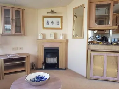 a living room with a fireplace and a bowl on a table at C8 in Aberystwyth