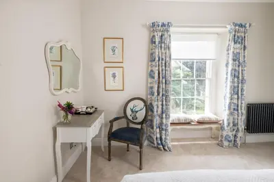 a bedroom with a window and a desk and a chair at Baskerville House in Clyro