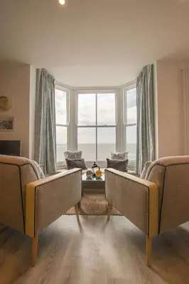 a living room with two couches and a large window at 1 Bed in Aberystwyth oc-bow286 in Aberystwyth