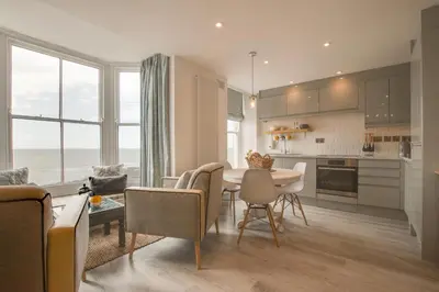 a kitchen and living room with a table and chairs at 1 Bed in Aberystwyth oc-bow286 in Aberystwyth
