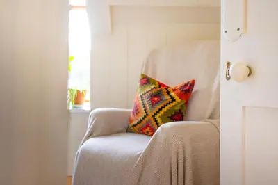 a pillow sitting on a chair in a room at Panoramic Mountain Retreat - Waen Fechan - 4x4 access only in Dolgellau