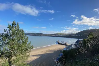 a beach with a boat in the water at 4 Bed in New Quay oc-bow272 in New Quay