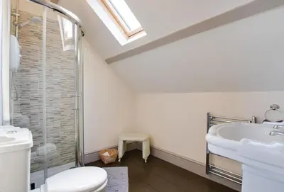 a white bathroom with a toilet and a sink at 4 Bed in New Quay oc-bow272 in New Quay