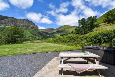 a picnic table with a view of mountains at 4 Bed in Dinas Mawddwy oc-bow305 in Aber Cowarch