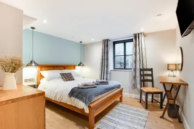 a bedroom with a bed and a desk and a window at 4 Bed in Dinas Mawddwy oc-bow305 in Aber Cowarch