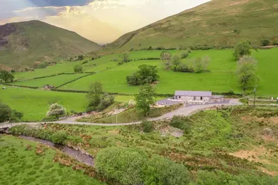 an aerial view of a farm in a green field at 4 Bed in Dinas Mawddwy oc-bow305 in Aber Cowarch