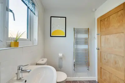a bathroom with a sink and a toilet and a window at 2 Bed in Tregaron oc-bow298 in Tregaron