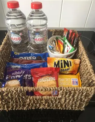 a basket with two bottles of water and snacks at Westend Holiday Let 3 Brecon in Brecon