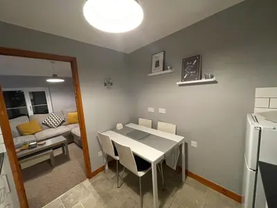 a kitchen and living room with a table and a couch at Westend Holiday Let 3 Brecon in Brecon