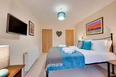 a bedroom with a large bed and a flat screen tv at 3 Bed in Machynlleth oc-bow306 in Darowen