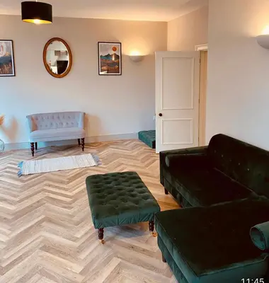 a living room with a couch and a table at NiCheGetaway in Shrewsbury