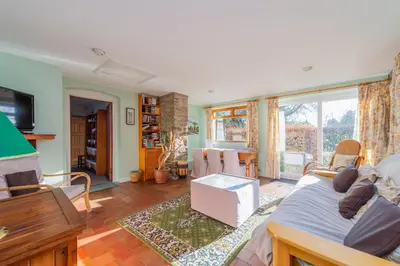 a living room with a couch and a table at Kwerky Cottage in North Lydbury