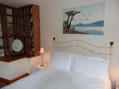 a bedroom with a bed with white pillows at Kwerky Cottage in North Lydbury