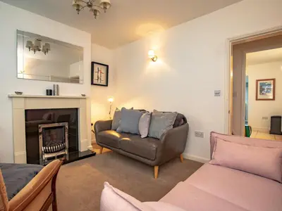 a living room with a couch and a chair at Pass the Keys 3 bedroom home within walking distance of town in Shrewsbury