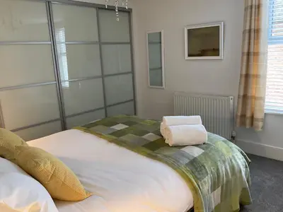 a bedroom with a large bed with a pillow on it at Pass the Keys 3 bedroom home within walking distance of town in Shrewsbury