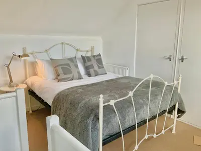 a bedroom with a bed with a metal frame at Pass the Keys 3 bedroom home within walking distance of town in Shrewsbury