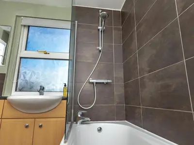 a bathroom with a shower and a sink and a tub at Pass the Keys 3 bedroom home within walking distance of town in Shrewsbury