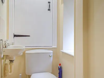 a bathroom with a white toilet and a sink at Border View in Kington