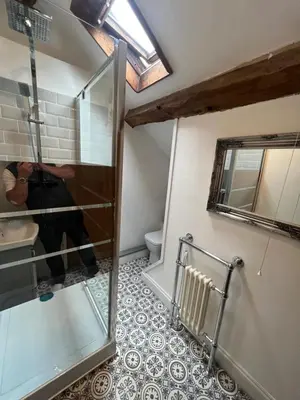 a bathroom with a glass shower and a toilet at Abbey Cottage in Llangollen