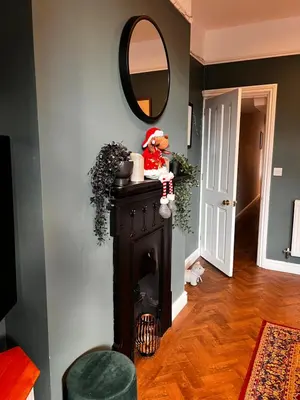 a teddy bear sitting on top of a fireplace in a room at Cartref - Fully equipped and stunning town flat in Shrewsbury