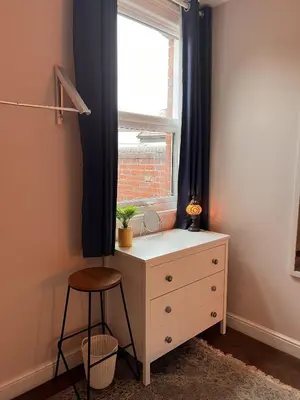 a bedroom with a dresser and a window at Cartref - Fully equipped and stunning town flat in Shrewsbury