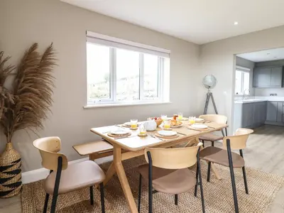 a dining room with a table and chairs at Bryn Hafod in Dyffryn
