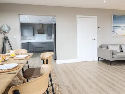 a kitchen and living room with a table and chairs at Bryn Hafod in Dyffryn