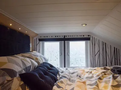 a bedroom with two beds in front of a window at Lake Vyrnwy Luxury Glamping Pod 2 in Llanwddyn