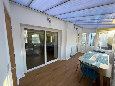 a room with a table and chairs and a dining room at Escapism Wales Garthowen in Llanrhystyd