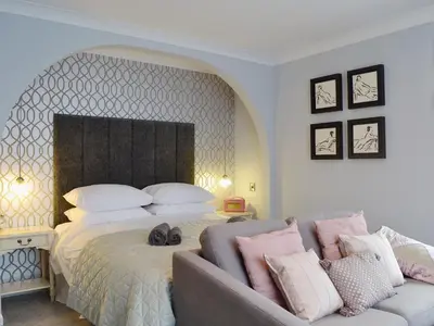a bedroom with a large bed and a couch at Seascape in Aberystwyth