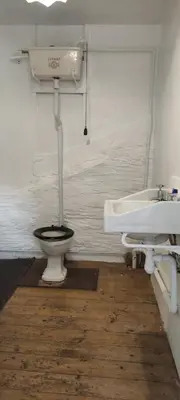 a bathroom with a toilet and a sink at Toad Hall Hostel in Machynlleth