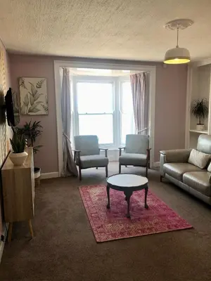a living room with a couch and a table at Cranwell Court Apartments in Aberystwyth