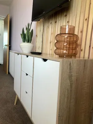 a kitchen with a white cabinet with a plant on it at Cranwell Court Apartments in Aberystwyth