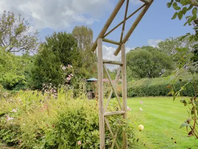 a wooden ladder in the middle of a garden at Denbigh Hall in Leominster