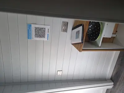 a room with white walls and a shelf with a bench at Glamping Hut - Riverview 3 in Welshpool