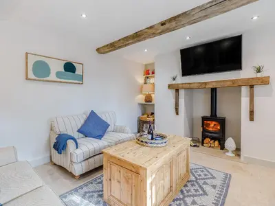 a living room with a couch and a fireplace at Little Whitley - Uk38099 in Great Hanwood
