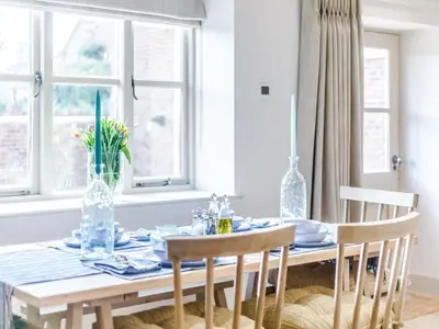 a dining room table with two chairs and a table with plates and glasses at Little Whitley - Uk38099 in Great Hanwood