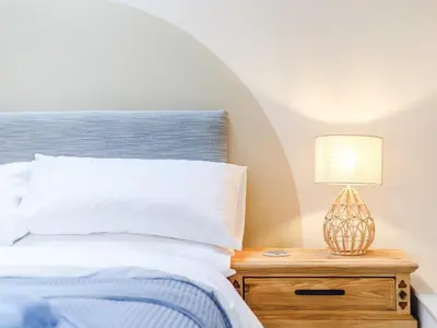 a bedroom with a bed and a lamp on a nightstand at Little Whitley - Uk38099 in Great Hanwood