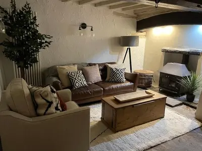 a living room with a couch and a coffee table at Penddol Cottage Llangollen in Llangollen