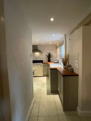 a kitchen with white appliances and a counter top at Penddol Cottage Llangollen in Llangollen