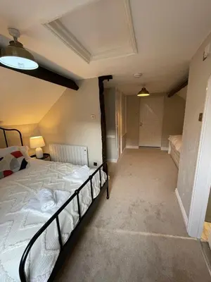 a bedroom with a large bed in a room at Penddol Cottage Llangollen in Llangollen